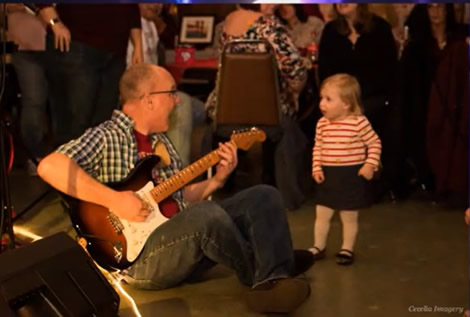 Doug playing and singing to a child